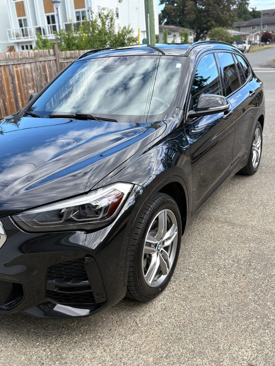 Freshly detailed black BMW X1 with a mirror-gloss finish