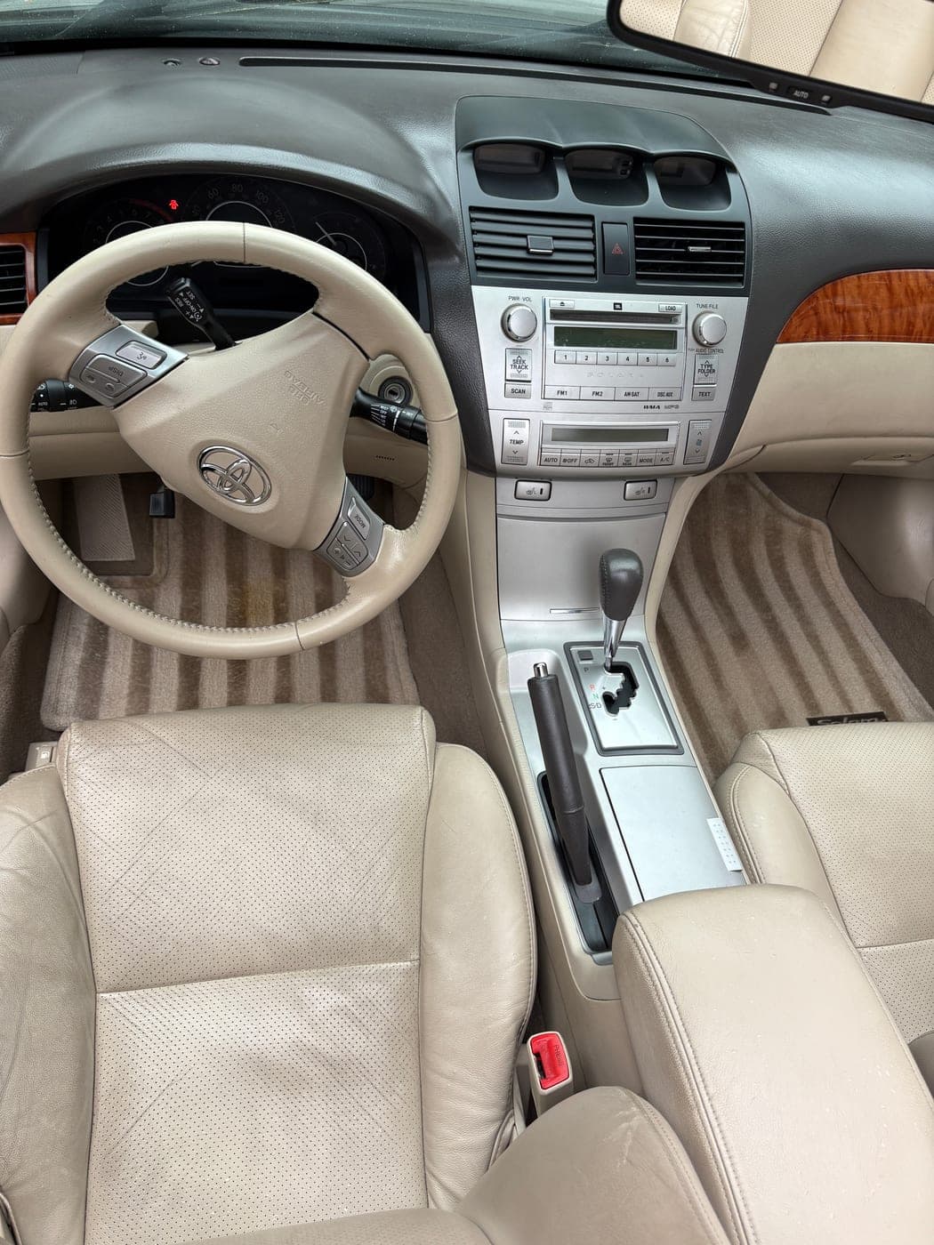 Conditioned tan leather interior and cleaned dashboard